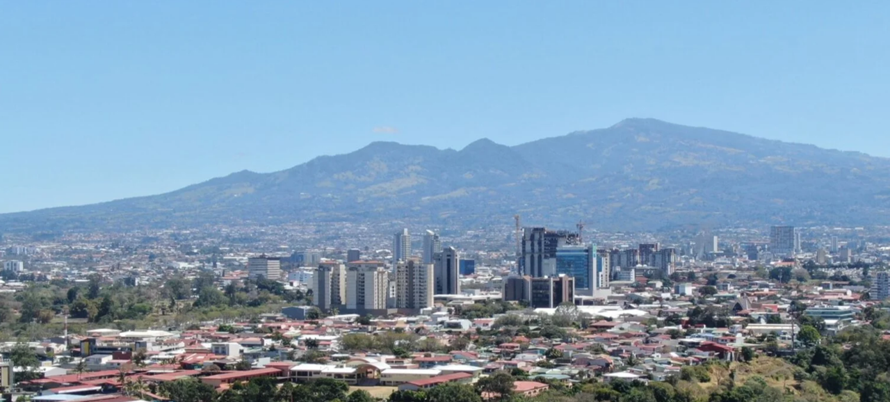 photo of a city landscape with mountains in background